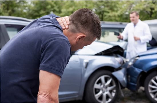 A man holding his neck in pain following a motor vehicle accident