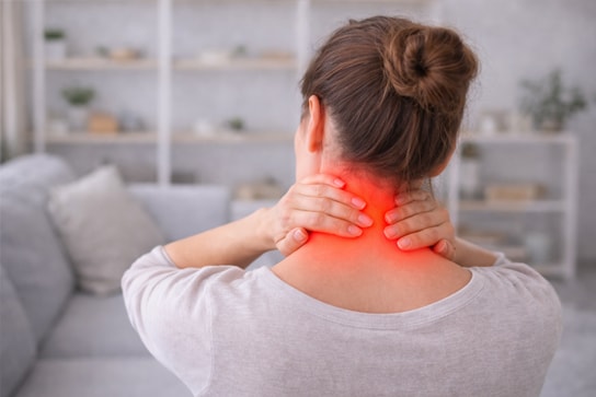 A chiropractor performing a gentle neck adjustment on a patient lying on a treatment table
