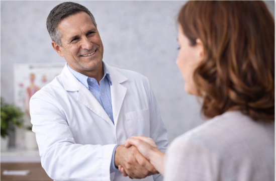 A chiropractor working with a patient on a treatment table to address shoulder discomfort
