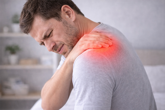 A chiropractor examining and mobilizing a patient's shoulder joint during a chiropractic assessment