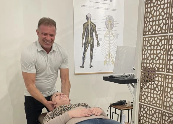 Chiropractor Calgary AB Michael Kricken Adjusting Patient