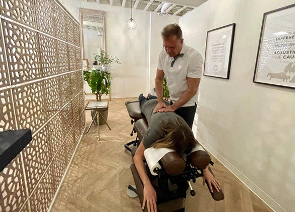 Chiropractor Calgary AB Michael Kricken Adjusting Patient